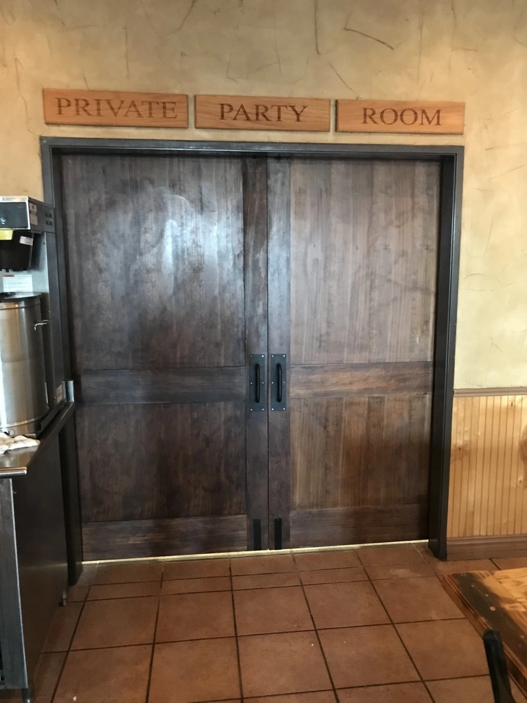 Private party room entrance with wooden doors