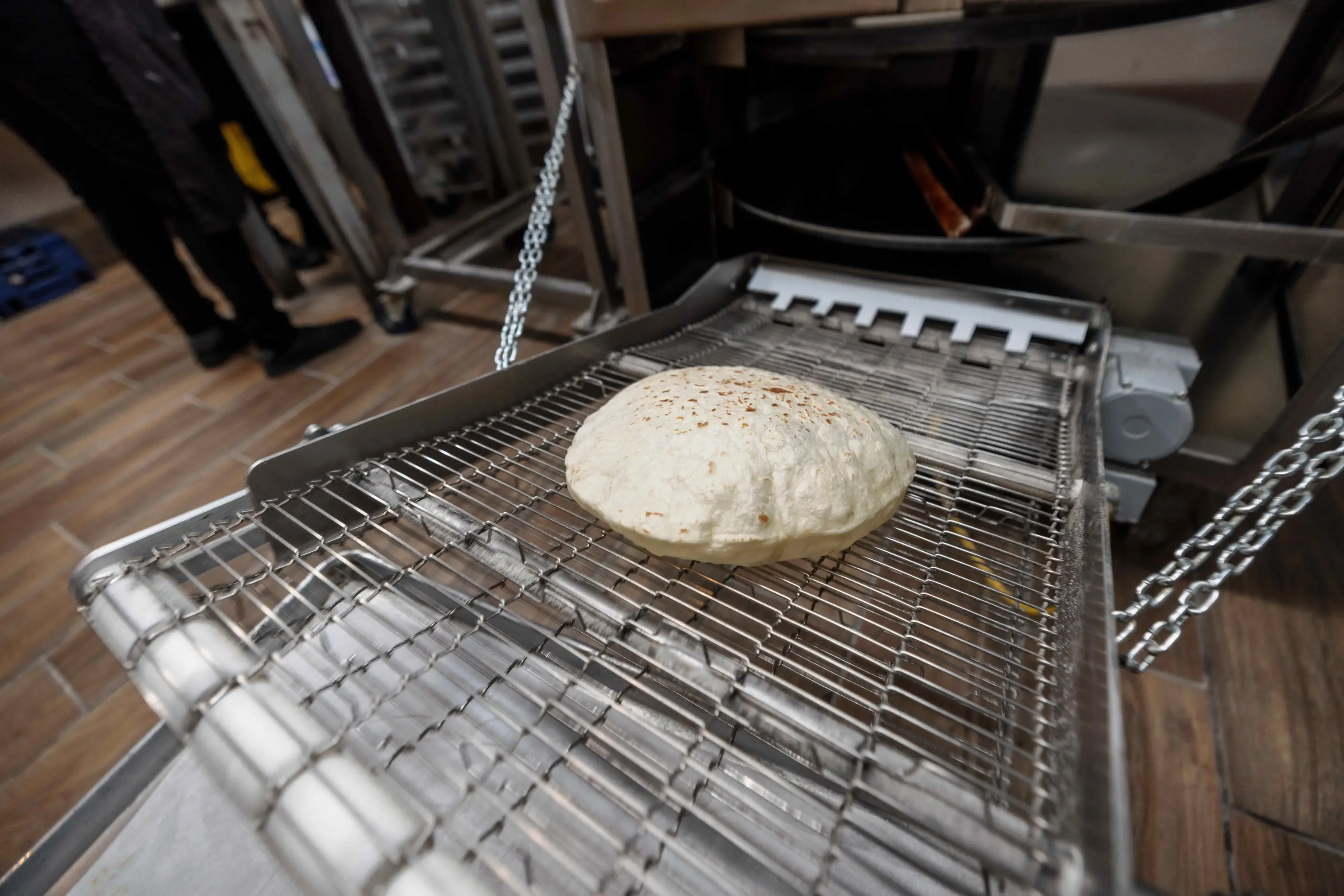 Friends laughing and sharing food at a Spanish restaurant