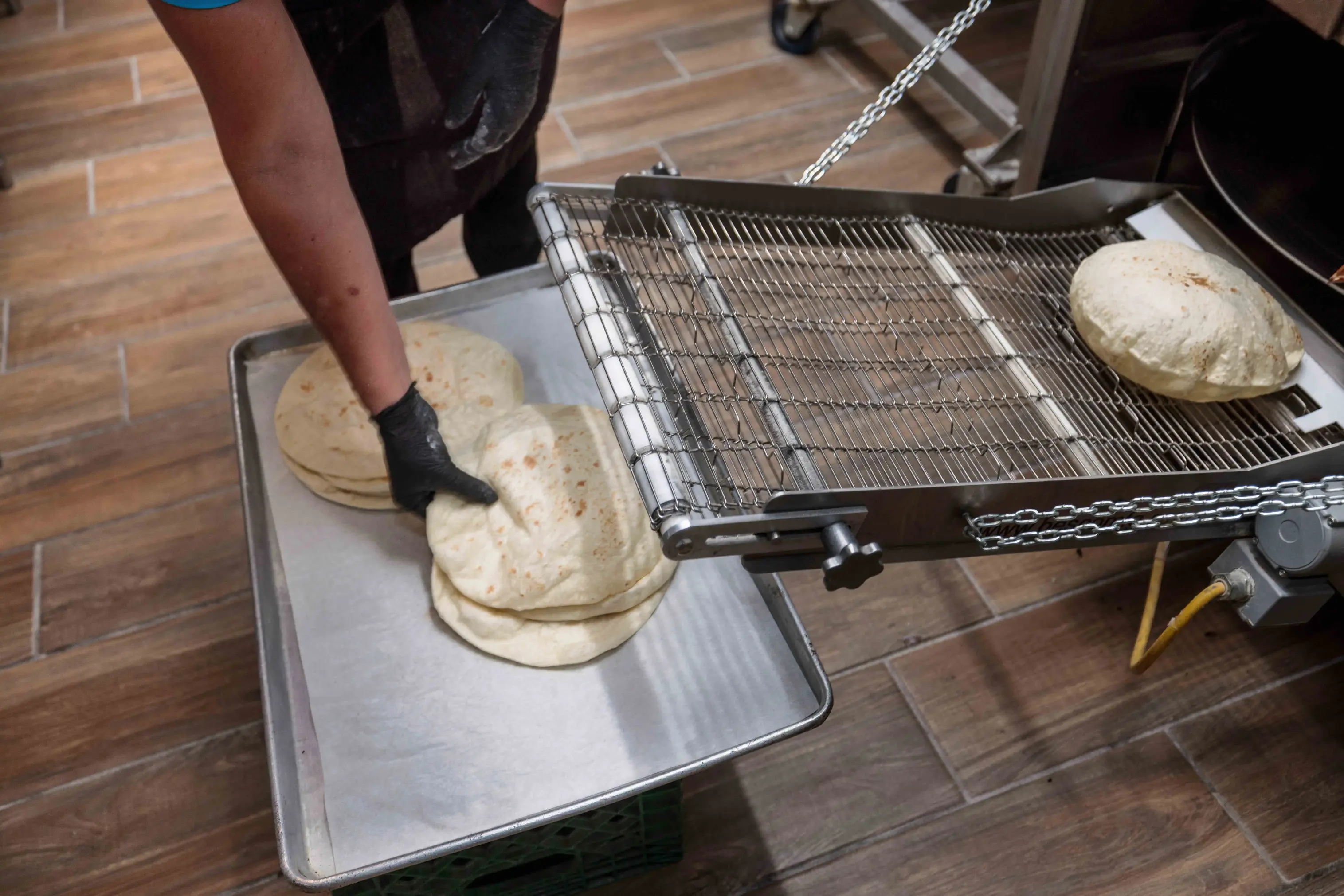 A shared dish of patatas bravas in the center of a table